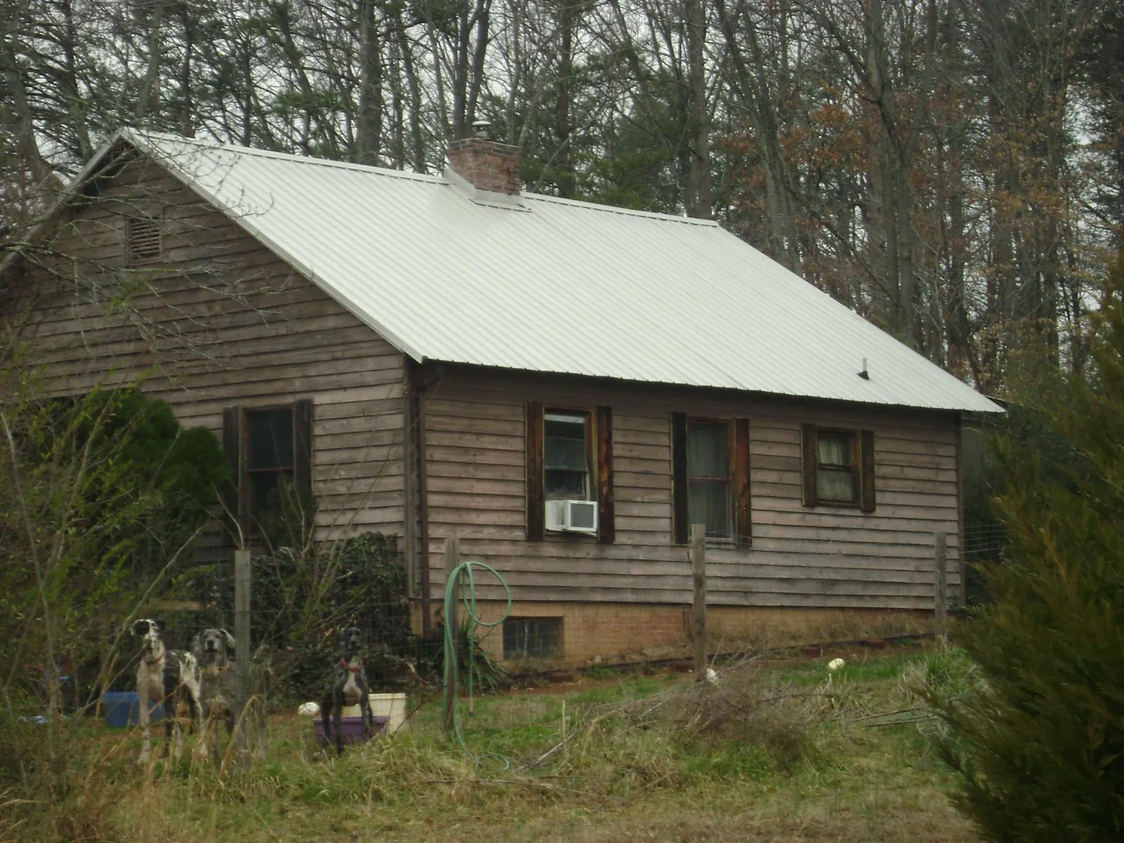 White metal roof on an old wood sided farmhouse, from a Metal Roof Installation job in Braddock Heights